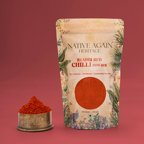 Native Again Heritage Ayadi Red Chilli Powder packaging with a small container of powder on a red background