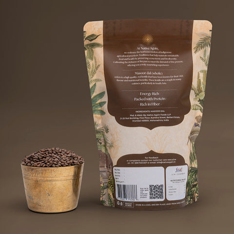 Bag of coffee beans with a wooden container on a brown background